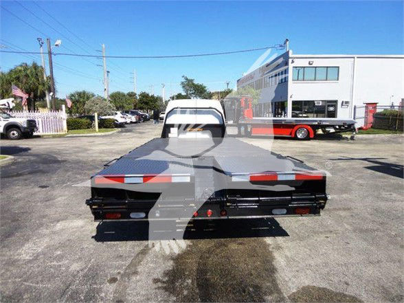 Flatbed tow truck bed rear view in a used 2011 Ford E450 listing with stock number T06273FM.