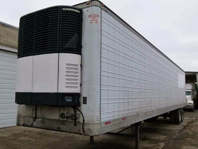Trailer refrigeration unit at front of a 2003 Trailmobile 48' reefer trailer with Carrier unit and white insulated panels.