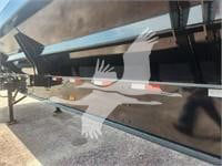Trailer side with black paint and white red stripe design showing stock number 392503 in dump trailer category.