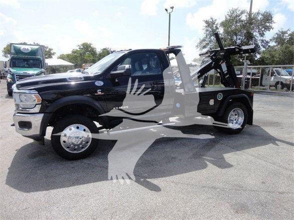 2024 Ram 4500 SLT pickup truck with tow equipment in a dealership lot, black color, side view.