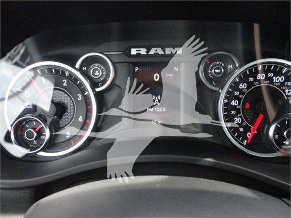 Ram truck instrument cluster showing speedometer, tachometer, and center digital display with PRND gear indicator and FM 102.5 radio frequency.