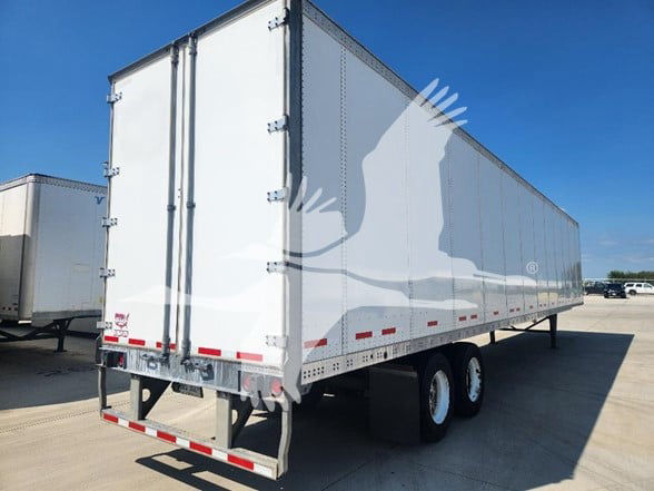 2018 Wabash trailer in a lot showing white dry van with double rear doors and tandem axles.