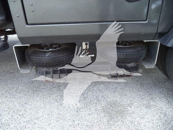 Ford F-450 undercarriage showing rear spare tires and hitch area with text tags: VIN, stock number, category, type, new/used.