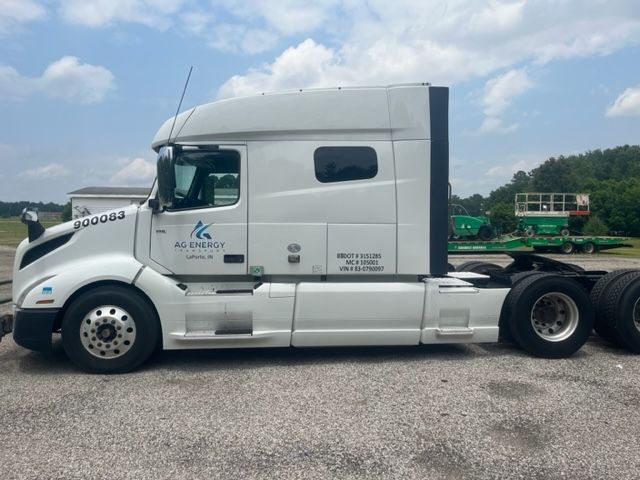 Volvo VNL64T740 sleeper cab truck side view showing AG Energy logo and stock number 900083.