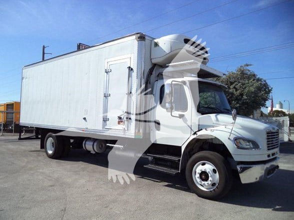Box truck with a refrigerated cargo box, white cab and box, side door open, parked on lot.
