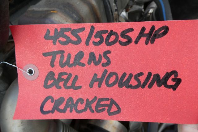 Tag with handwritten note describing engine: '455/1505 HP turns bell housing cracked' attached to Detroit DD15 engine component.