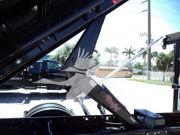 Chevrolet Silverado 6500HD truck component showing hydraulic lift and support arm with label markings.