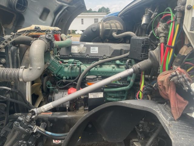 Volvo VNL64T740 engine bay showing diesel engine, intercooler pipes, hoses, and various colored wiring harnesses.