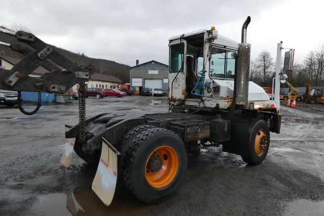 Used 2001 Capacity TJ5000 yard truck with cab, hook attachment, and orange wheels in a parking lot.