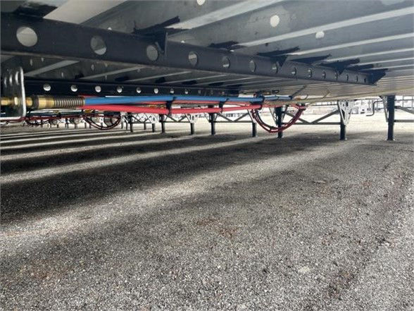 Underframe of a CIMC Cool Globe Reefer Van trailer showing hoses and frame components.
