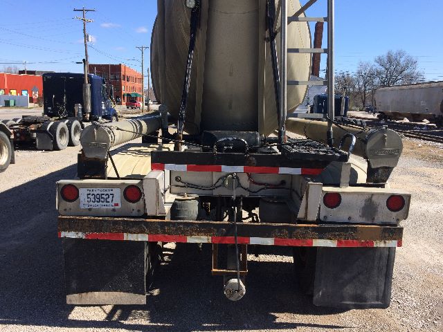 Rear view of Fruehauf pneumatic dry bulk trailer showing rear bumper, taillights, mud flaps, and license plate.