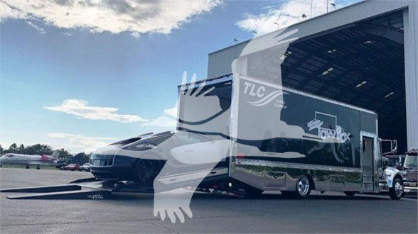 2022 Peterbilt 337 tow truck in a dealership lot with a multi-axle trailer and loading ramp visible, stock number J56602.