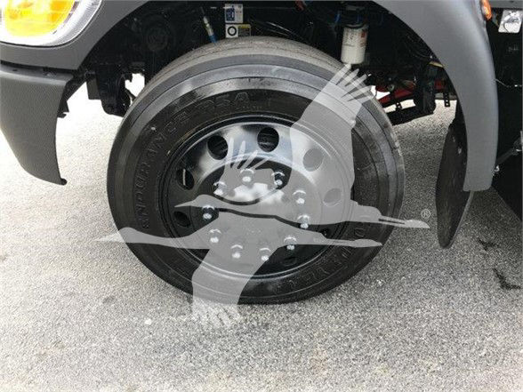 Wheel and front suspension of a 2022 Peterbilt 337 with hub, tire, and fender visible. Overlay watermark partly obscures wheel.