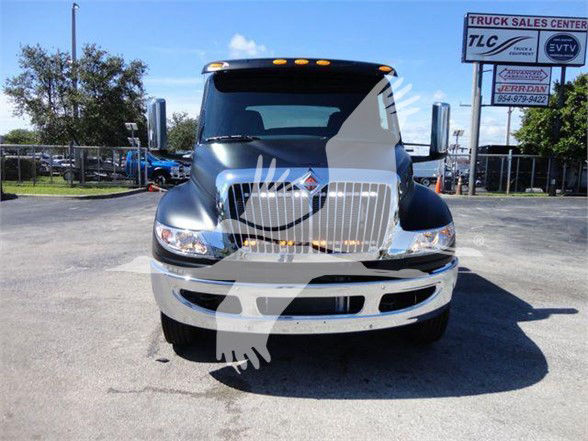 Truck front view showing chrome grille and bumper with overlayed watermark figure.