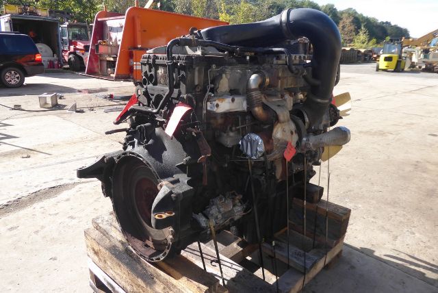 Detroit DD13 engine core on pallet with intake manifold and hoses visible