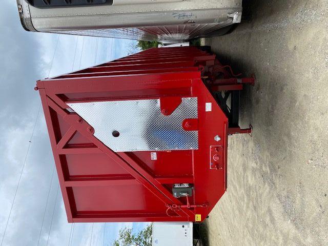 Crush car carrier trailer end with red steel framing and diagonal bracing, diamond plate access panel, and trailer legs.