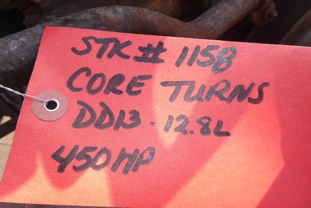 Red tag with handwritten text: '5TK #1158 CORE TURNS DDI3 12.8L 450 HP' attached to engine component.