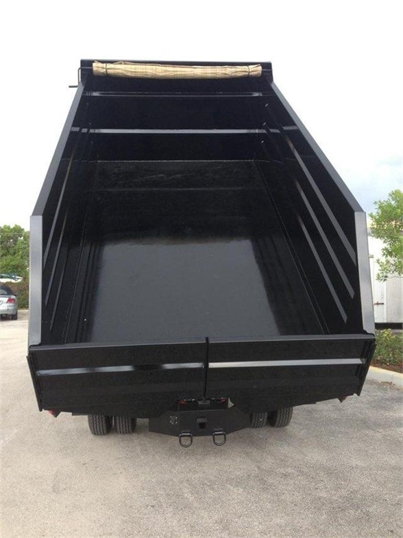 Dump body bed of a 14 ft Advanced Fabricators dump trailer showing open-top steel box with side rails and tailgate, hitch, and dual rear wheels.