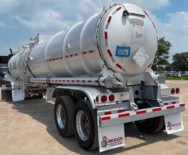 Dragon aluminum crude oil tank trailer back view with dual rear axles and safety decals.