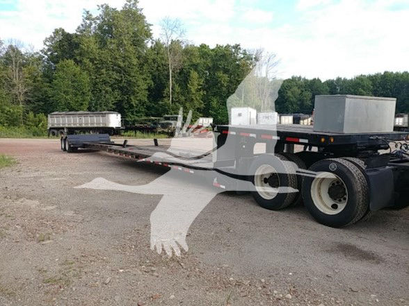 XL Specialized XL70MDE lowboy trailer showing flatbed with long frame and dual rear axles. Visible text on side plates and components is not legible; overall equipment appears used.