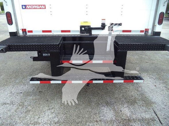 Back of a Chevrolet Silverado 6500HD box truck with black rear bumper steps and a reflective strip.