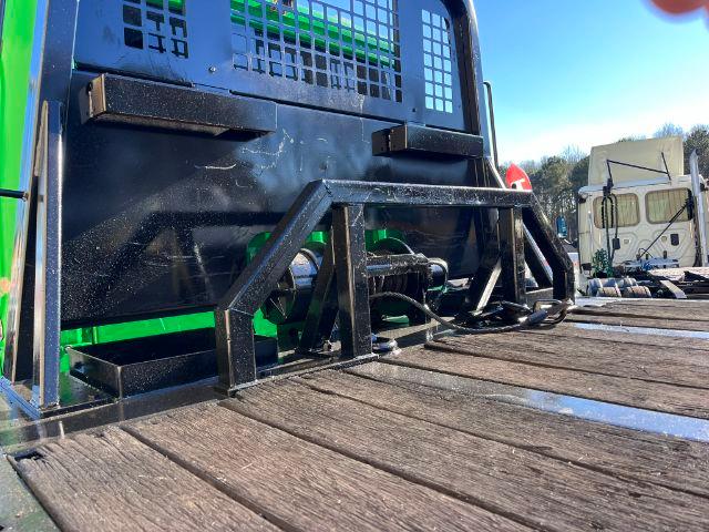 Flatbed of a 2016 Freightliner M2 106 rollback truck with a metal headache rack and hydraulic lines visible on the bed.