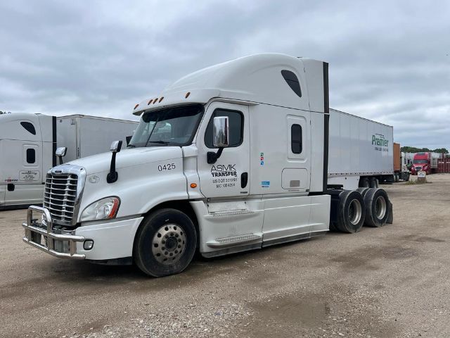 Freightliner Cascadia tractor-trailer in a used fleet yard showing cab and attached 53ft trailer.
