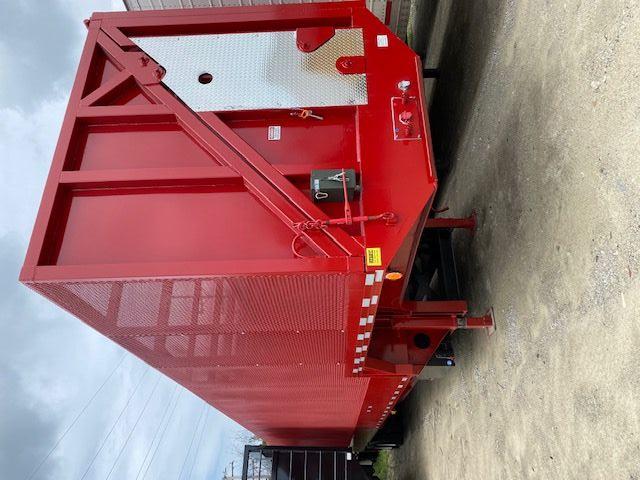 Transcraft 48 ft crusher/crush car carrier trailer in red viewed from rear-left side showing gooseneck area and metal diamond plate access panel.