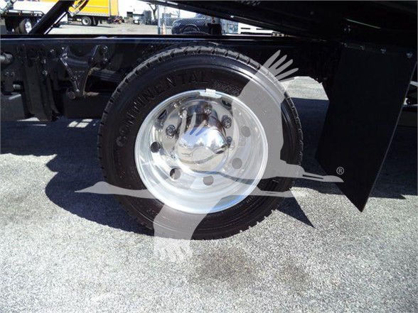 Chevrolet Silverado 6500HD wheel and tire assembly showing steel rim with hubcap and tire sidewall details.