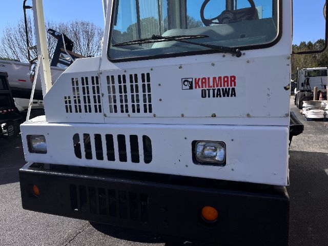 Front view of a white Kalmar Ottawa yard truck with grille vents, two square headlights, and Kalmar Ottawa logo on the cab.