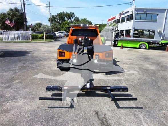 Ram 4500 SLT tow truck with a front hitch and equipment in the bed; front view shows tie-downs and strobe lights