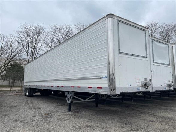 Rear and side view of a silver CIMC Cool Globe refrigerated trailer with dual doors, spare wheel, and support legs.