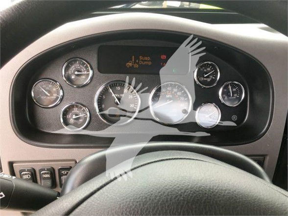 Peterbilt 337 instrument cluster dashboard showing multiple gauges and a central display reading 'Susp bumper' with steering wheel in foreground.