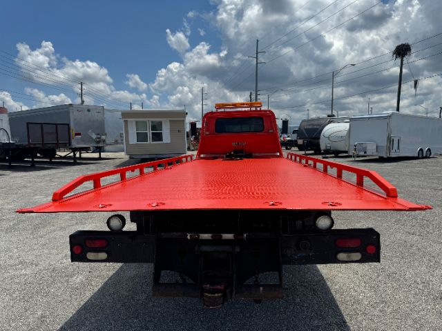 Tow truck bed with bright red flatbed and rear lights visible, DT 466E engine badge not visible.