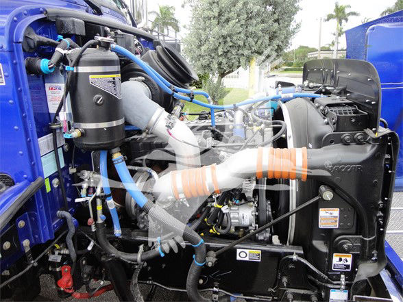 Peterbilt 337 engine bay showing blue hoses and turbocharger components.