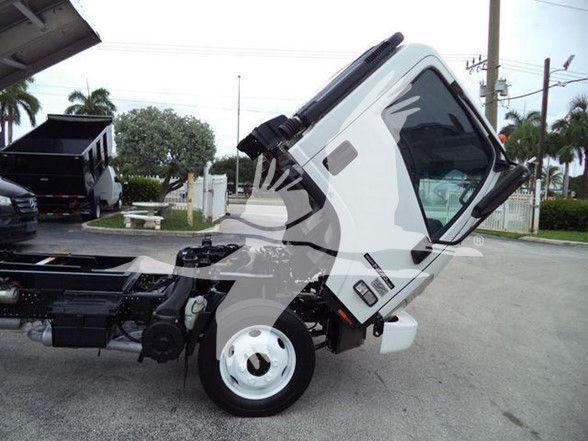 Isuzu NPR HD cab tilted forward showing front wheel and chassis with a white cab.