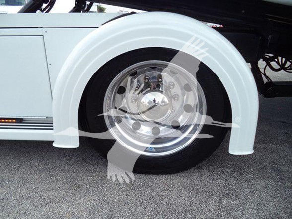 Peterbilt 337 wheel and white fender with chrome hubcap and wheel well.