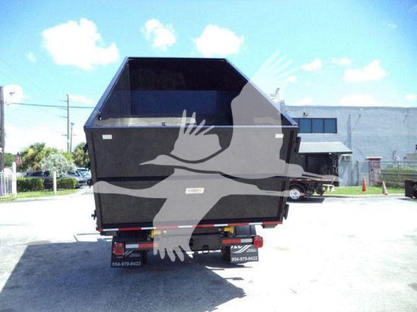 Back of a dump bed Ram 5500 HD SLT truck. Tailgate/dump bed with rear lights and bumper. Visible small decals or stickers on the lower rear area.
