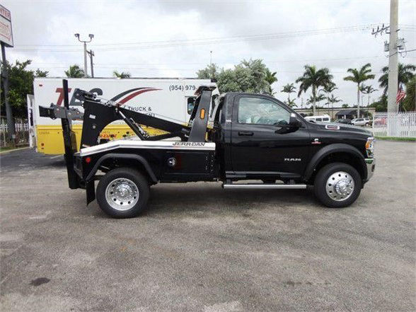 2024 Ram 4500 SLT tow truck side view with black cab and hook-lift system