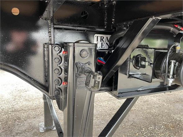  Fontaine XCALIBUR extendable all steel flatbed trailer hitch area showing frame, hydraulic components, and support brackets.