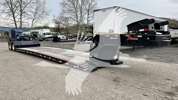 XL Specialized Mini Deck trailer with long flatbed and hydraulic ramps, side rails, and pivoting gooseneck rams. Visible branding includes 'XL', 'Specialized', and hydraulic components.
