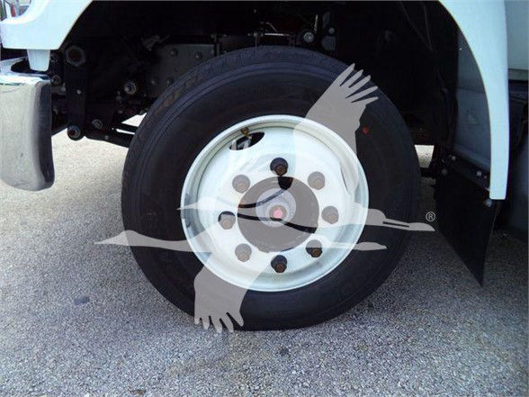 Front wheel and tire of a Ford F650 SD truck showing wheel hub and tire with fender and chassis components visible.