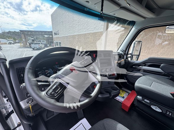 Interior of a 2026 Kenworth T880 cab showing steering wheel and dashboard with controls and center console.