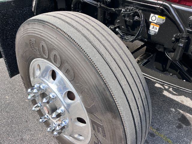 Kenworth T800 front wheel and tire close-up in truck chassis showing Goodyear tire and polished steel wheel