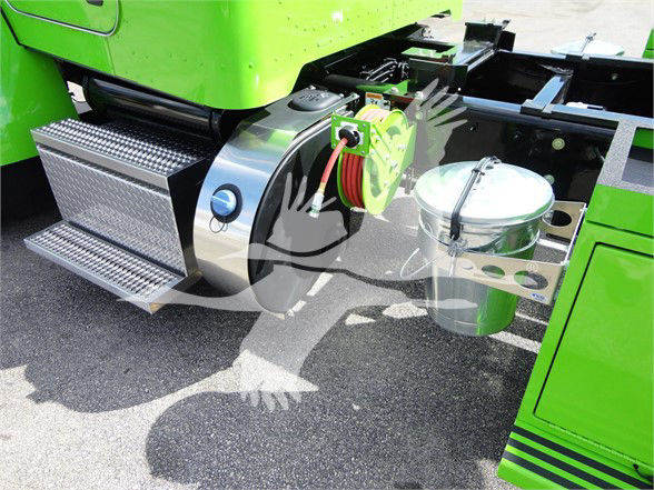 Truck fuel tank and step area of a bright green Peterbilt 337, showing chrome fuel tank with cap, red hose reel, and side steps.