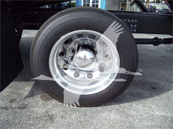 Truck wheel showing chrome hubcap and black tire on a Mack MD6 chassis.