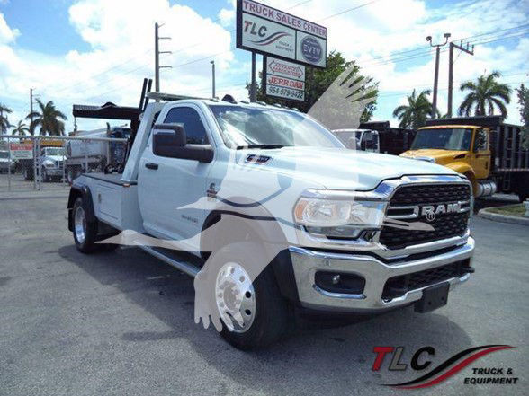 Ram 4500 heavy-duty truck in a dealership lot with towing setup and branding TLC Truck & Equipment.