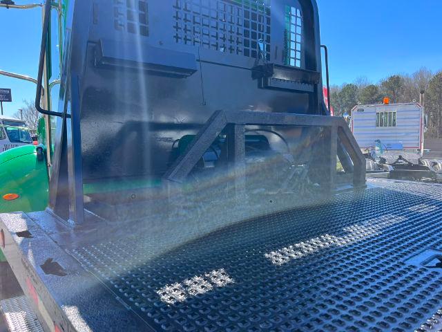 Peterbilt 348 rollback truck rear cab area and flatbed with steel diamond plate deck.