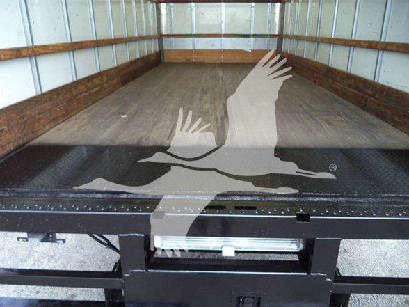  Ford E450 box truck bed showing empty cargo area with wooden side rails.
