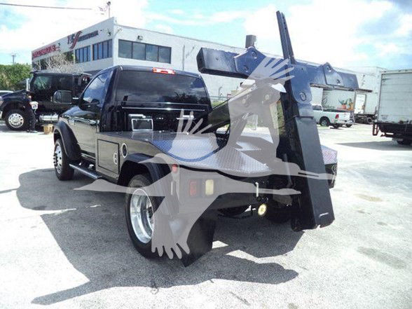 2018 Ram 4500 SLT truck with a large tow hitch and mounted crane equipment in a parking lot.
